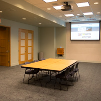 event space meeting room, table, chairs and powerpoint projector